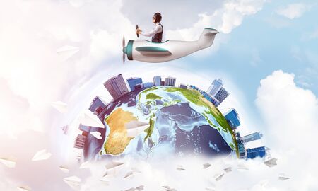 Man in aviator hat with goggles driving propeller plane. Earth globe ...
