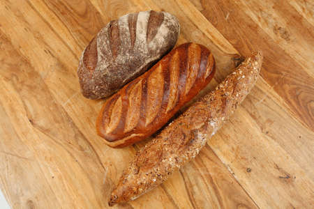 different rye and white flour bread loaf with french fresh baguette on ...