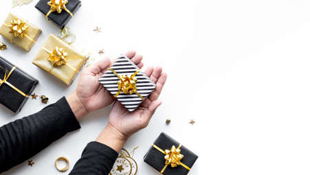 hands holding gold and silver jewelry