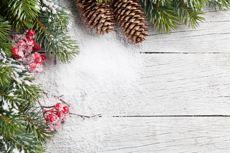 Christmas background with snow fir tree on wooden table. Top view with ...