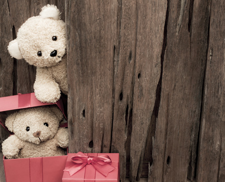Cute teddy bears with red gift box on old wood background with copy ...