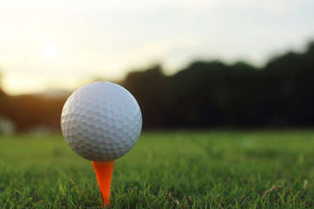 golf ball on tee in a beautiful golf course with morning sunshine.Ready for golf in the first short.Sports that people around the world play during the holidays for health.