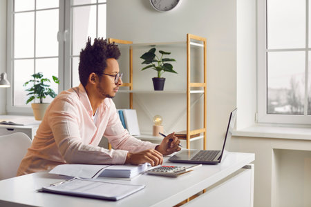 Side view of a young african american attractive business man working ...