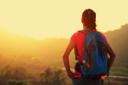 young woman hiker enjoy the view at sunrise mountain peak - Stock Image ...