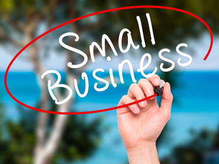 Man Hand writing Small Business with black marker on visual screen ...