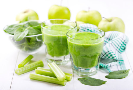 glasses of green juice with apple and spinach on wooden table - Stock ...