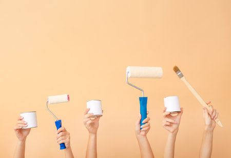 Female hands with painter's tools on color background - Stock Image ...