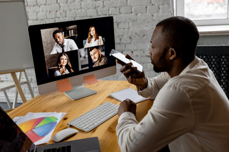 African american male freelancer talking and discussing coworkers on ...