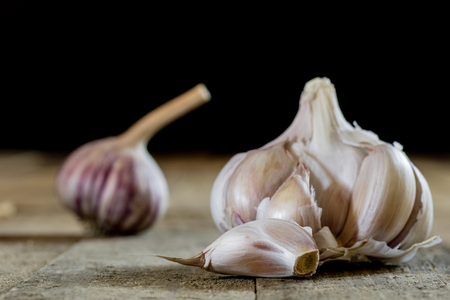 Tasty garlic on a wooden kitchen table. Vegetables in the kitchen ...