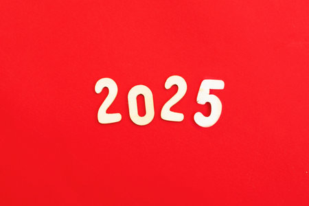 Wooden numbers 2025 on red ...