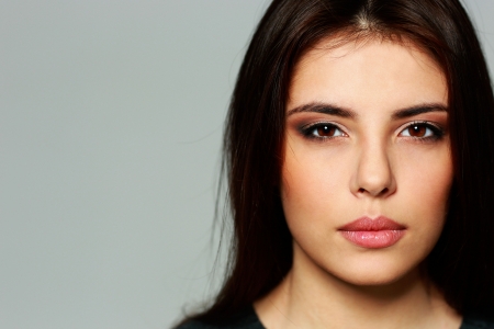 Closeup portrait of a young mysterious woman on gray background - Stock ...