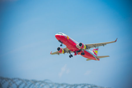 A red and white aircraft landing at the airportの写真素材