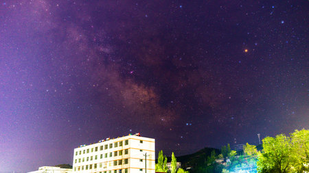 Milky way and the city at night. Long exposure photograph.