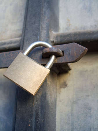 Padlock on old rusty door