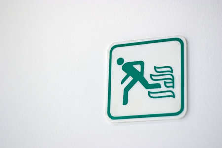 Fire exit sign on white wallの写真素材