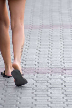 Sexy female legs walking down the streetの写真素材