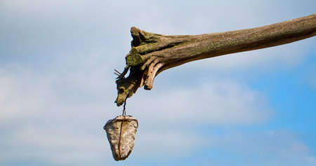 Stone hanging on rotten joistの写真素材