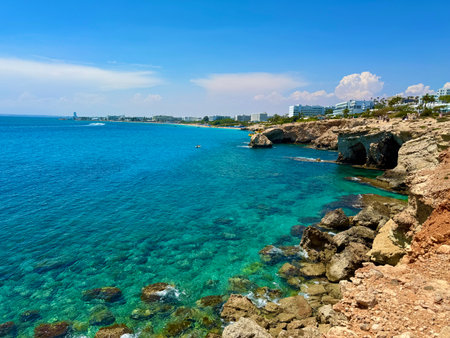 Picturesque beach, waves crashing on the sandy shore. Sea waves beat against the rocks. Mediterranean Sea.の写真素材