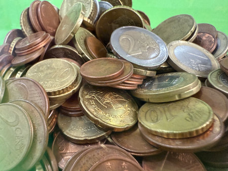 Close-up of Euro coins in container. Glass piggy bank for money. Saving money to buy necessary...