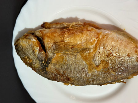 A close-up shot of fried fish. Cooking delicious food at home.
