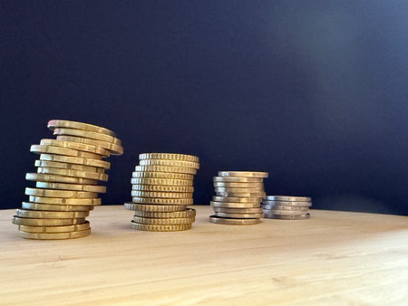 Macro photography of coins highlighting financial themes such as pensions, taxes, income, and...