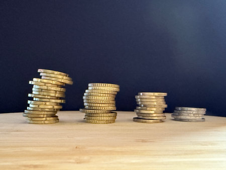 Macro photography of coins highlighting financial themes such as pensions, taxes, income, and losses. Money, economics, and financial literacy.の写真素材