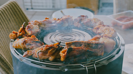 Grilled chicken on a barbecue grill. Selective focus. Toned.の写真素材