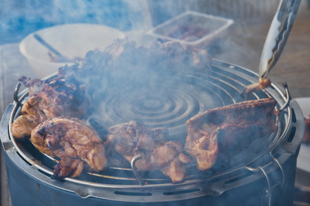 Grilled chicken on a barbecue in a restaurant, close-upの写真素材