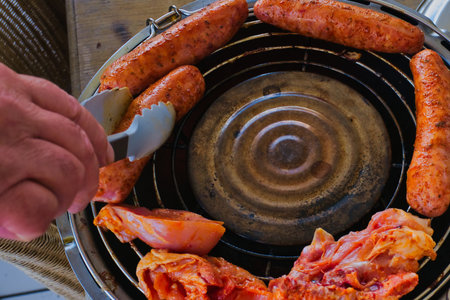 grilling sausages on a barbecue grill, close-up