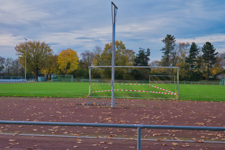 Soccer goal and net on an empty soccer field in autumn.