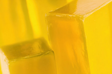 Geometric yellow shapes rest on a glass surface, showing a minimal and clean modern aesthetic.の素材