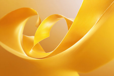 A yellow ribbon swirls gracefully in soft light against a warm background, showing its smooth texture and curves.の素材