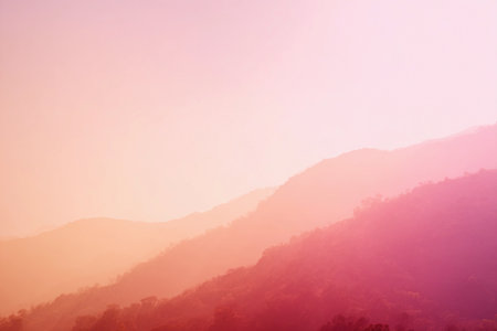 A gentle sunset bathes the mountains in warm pastel colors, creating a peaceful and serene atmosphere.の素材