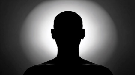 A glowing outline of a person stands against a large, empty space during twilight.の素材