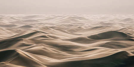 Dunes stretch endlessly, wind creates soft patterns across the sandy surface at dusk.の素材