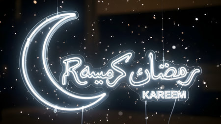 Neon sign of Ramadan Kareem in front of the window at nightの素材
