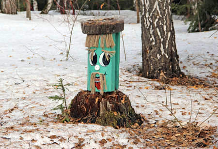 Funny face made of timber, with eyebrows and a mustache.の写真素材