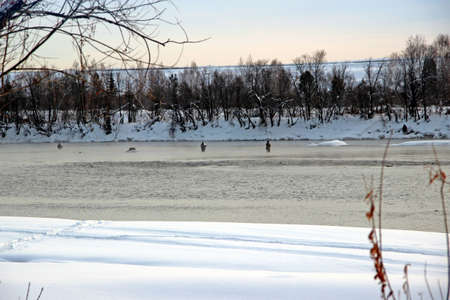Winter fishing is an extraordinary activity - standing waist-deep in ice water.の写真素材