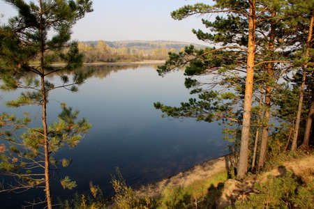 View of the calm surface of the river from the steep Bank in autumn.の写真素材