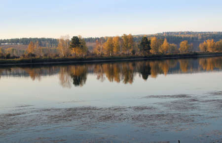 View on the tranquil river surface where reflected autumn landscape such as in a great mirror.の写真素材