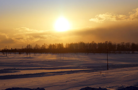 Winter landscape of the countryside at sunset.の写真素材