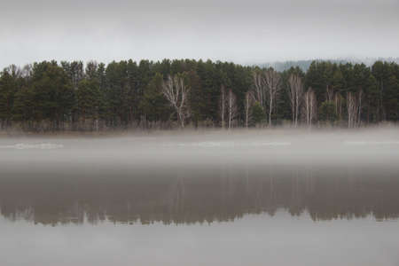 Vintage images of dense fog lying on the river waterの写真素材