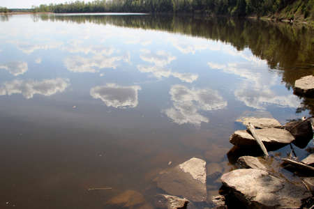 Amazing spring scene of the cloud pieces reflection in river surface. Wonderful pictureの写真素材
