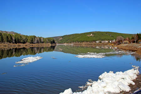 Spring landscape of ice islands flowing by river water. Blue sky and waterの写真素材