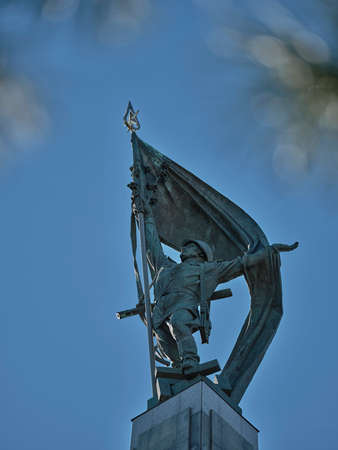 Metal statue of russian soldier with flag on the Slavin monument top in Bratislavaのeditorial素材