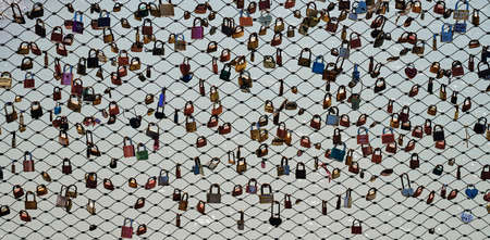 The fence of the bridge hung with many colored locks, Salzburg, Austria, background, textureのeditorial素材