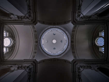 The ceiling of a baroque church with a circular opening and windows in symmetry in Salzburg, Austriaのeditorial素材