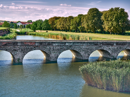 Old arched brick bridge over the river in Holic, Slovakiaの写真素材