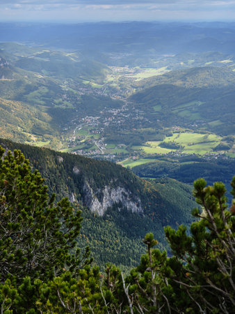 View of the surrounding villages and hills from the Rax mountain range in Austriaの写真素材