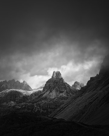 Rock tower mountain somewhere in black and white in Dolomites, Italy